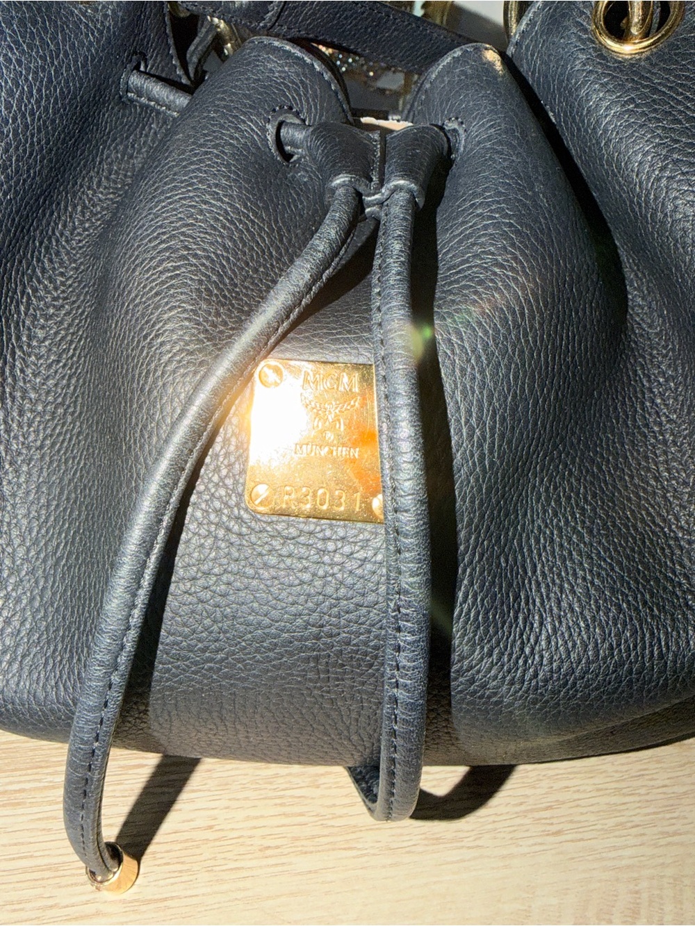 MCM Black Pebbled Leather Drawstring Bucket Bag with Gold Plaque